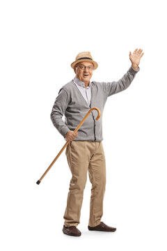 Elderly man holding a cane and waving