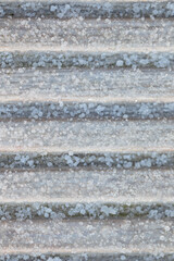 Small snowflakes on a wooden plank outside. First snow. Wood care