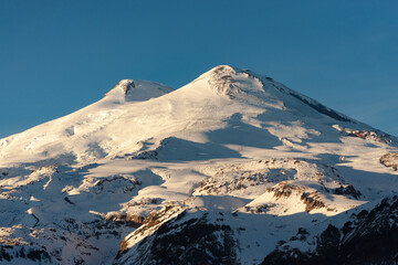 Mount Elbrus in winter. View of Elbrus from the nearby Cheget Mountain. Hats of Elbrus in the winter of 2021