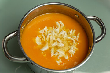 pumpkin cream soup with chicken in a metal pan
