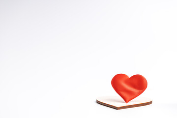 Fototapeta premium couple hearts red one and wooden over white background. love and romance concept. valentine day greeting card conceptual
