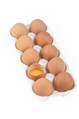 Rows of chicken eggs in a plastic substrate over white background.