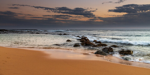 Sunset, rocks and the sea