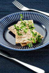 Crispy bread on a blue plate with a diet vegetable