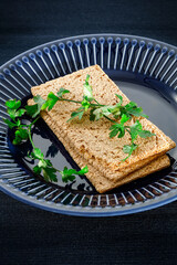 Crispy bread on a blue plate with a diet vegetable