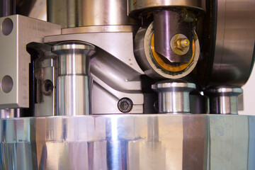 Movement of the punch along the guide chute of the rotary tablet press of the pharmaceutical laboratory for the production and testing of medicines.