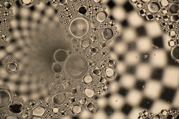 Black and White Oil and Water Abstract Photo. Different sized circles of black, white and grey.