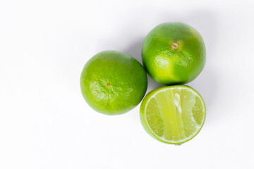 Green lime, sliced in half spokes on a white background, the view from the top.