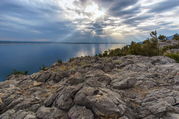 The sun's rays passing through clouds over the croatian sea