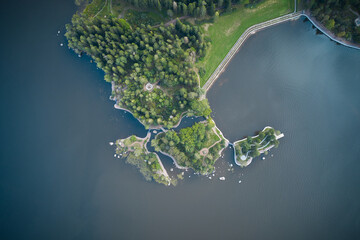 Aerial view of green peninsula with small islands in a lake