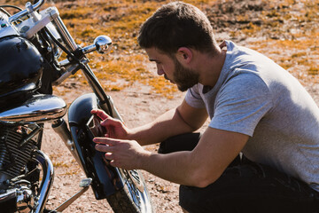 Obraz premium Biker taking a picture of the breakdown of his motorcycle