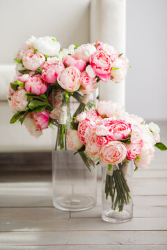 Bouquet of artificial peony flowers on a white tablecloth