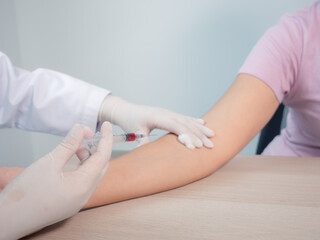 hand of a doctor holding vaccine Syringe. Persons administering vaccinations, doctor use hand cleansed with an alcohol-based giving vaccine injection to a patient. protection and antibiotic for corona
