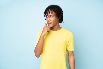 Young african american man isolated on blue background nervous and scared