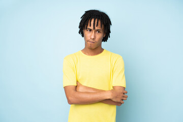 Young african american man isolated on blue background feeling upset