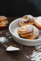 Jast baked cruffins on a white plate, food background