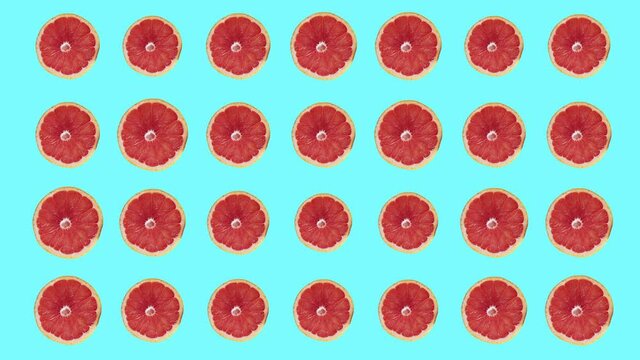Pink grapefruits animated against pale blue background