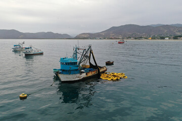 Fototapeta na wymiar Close up of a small fishing boat with a fishingnet floating alongside