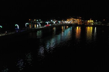 A bridge over a large river illuminated with white lights