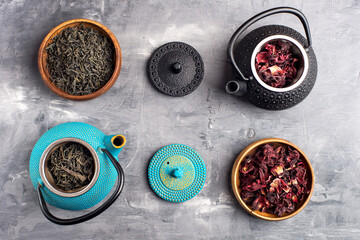 various teas prepared for brewing in different teapots
