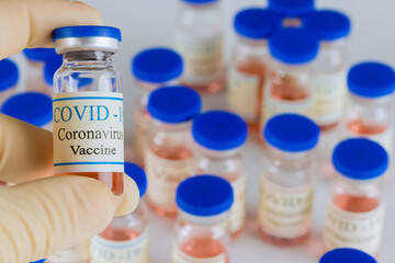 The doctor gives an treatment a vaccine bottles for coronavirus to fight the coronavirus pandemic vaccine SARS-COV-2, COVID-19