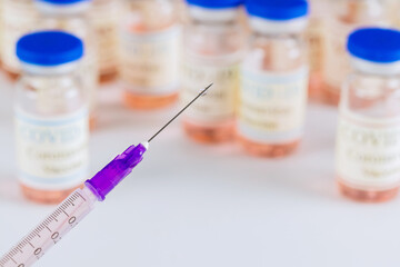 Healthcare syringe on vial with bottle with coronavirus vaccine developed for protection against COVID-19