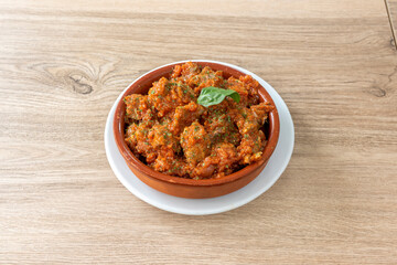 lean with tomato in clay pot