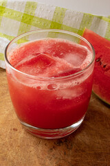 Glass with watermelon juice and ice cubes
