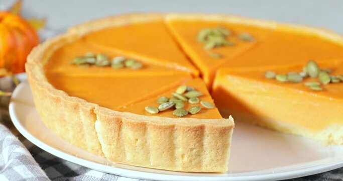 Taking of tasty pumpkin pie slice from plate, closeup