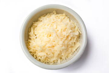 Top view of small ceramic pot with grated cheese. Isolated on white background