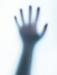 Photo of a blurred paranormal human ghost hand on white background.