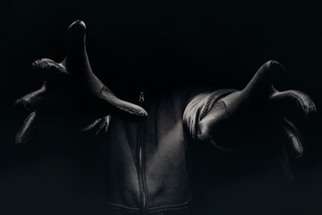 Horror photo of a scary man hands reaching out from darkness with fog. - obrazy, fototapety, plakaty