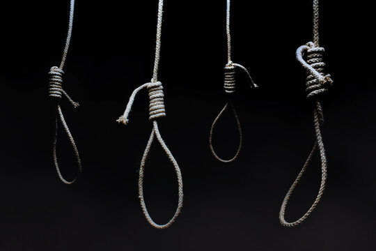 Horror photo of a dark scary hanging nooses on black background.