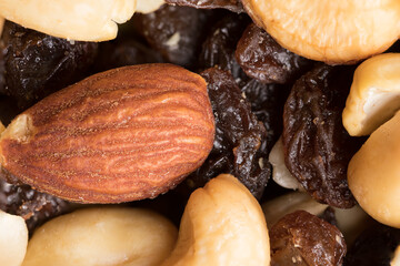 A Macro image of raisins and nuts in a healthy trail-mix ready for snacking