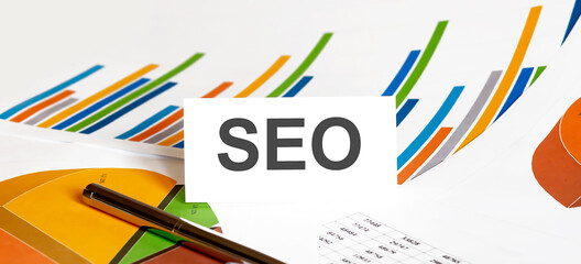 SEO text on paper on the chart background with pen