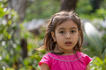 Girl in pink dress and little black eyes very expressive