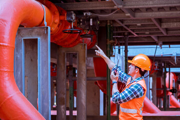 Engineer under checking the industry cooling tower air conditioner is water condenser cooling tower...