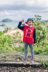 Fototapeta premium The boy is traveling near the beach