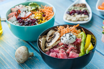 Hawaiian salmon, tuna and shrimp poke bowls with seaweed, avocado, mango, pickled ginger, sesame seeds. 