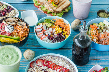 Hawaiian salmon, tuna and shrimp poke bowls with seaweed, avocado, mango, pickled ginger, sesame seeds. 