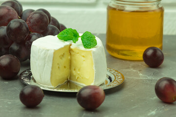 Fresh honey and camembert cheese close-up with space for text