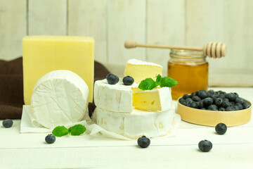 Fresh honey and camembert cheese close-up with space for text