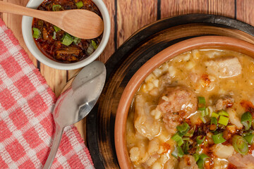 close-up of Ceramic bowl with typical Argentine cuisine Locro and the spicy sauce that accompanies...