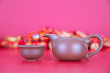 Zisha justice cup and tea bowl in front of red back