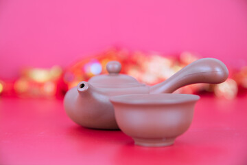 Purple Clay Pot and Tea Bowl on Red Background