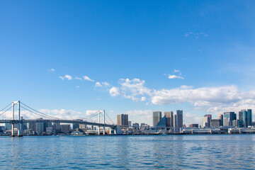 Naklejka premium Tokyo cityscape with the rainbow bridge against the blue sky