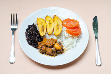 Typical panamanian daily life food.  Most of the times it includes rice, meat, salad and beans. Slices of ripe plantain are common side dish