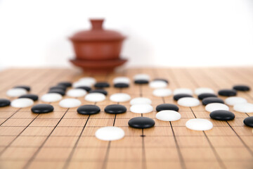 Chess pieces and tea set background on chess board