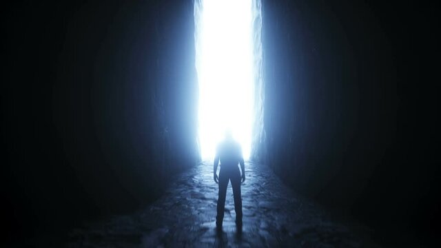 a lonely man stands in front of a moving light portal.