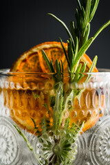 Old fasioned gin based cocktail with triple sec on the rustic background. Selective focus. Shallow...